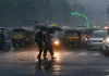 Delhi-NCR Weather Update: IMD Issues Orange Alert for Intense Evening Showers Traffic headlights reflecting on a rain-slicked urban highway in New Delhi under heavy, dark evening storm clouds.